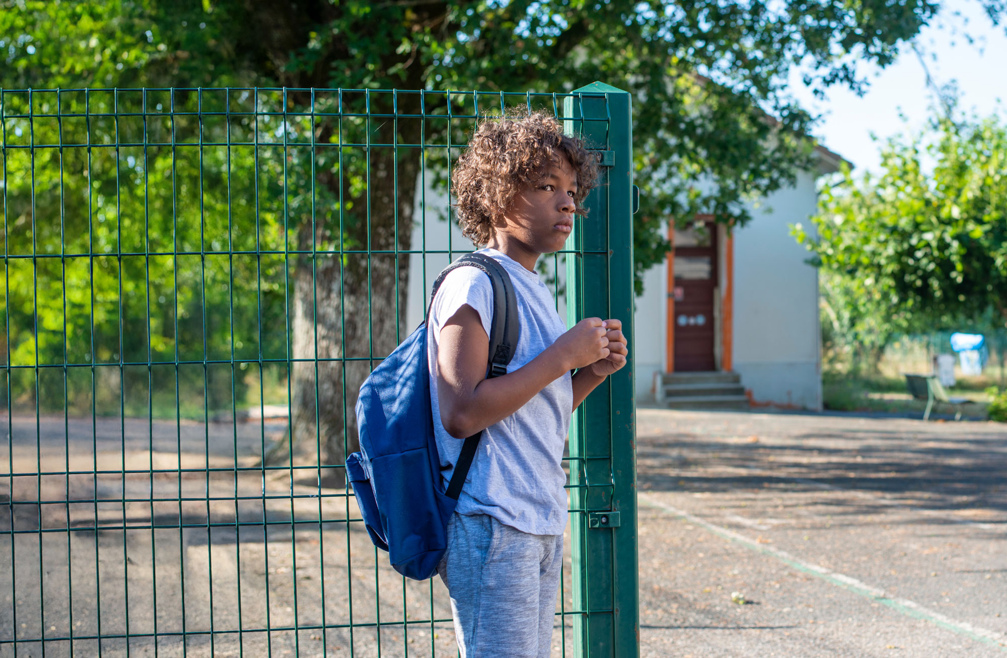 foster care child with backpack outside in Vancouver Washington neighborhood