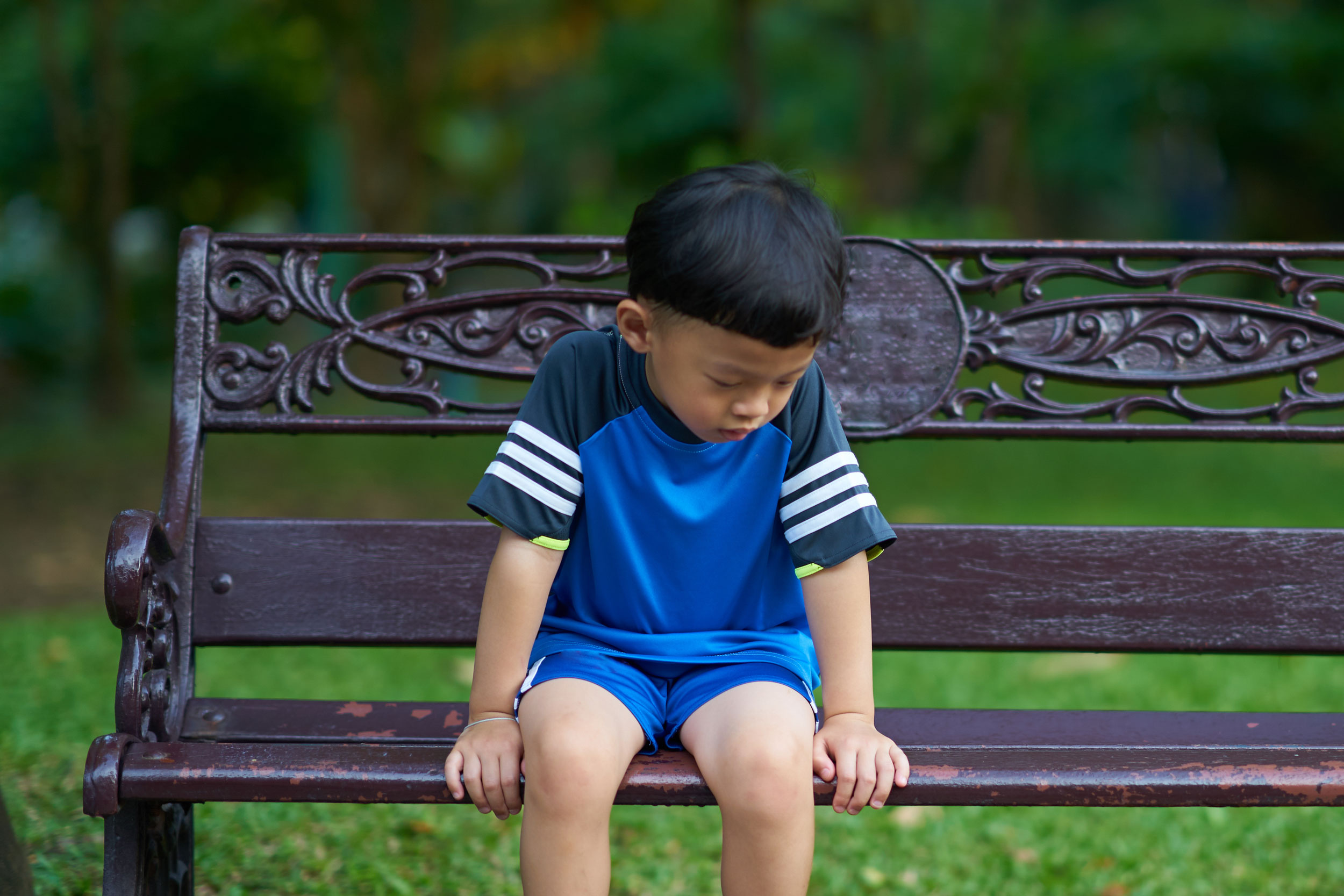 sad foster care child sitting on bench in Lakewood Washington