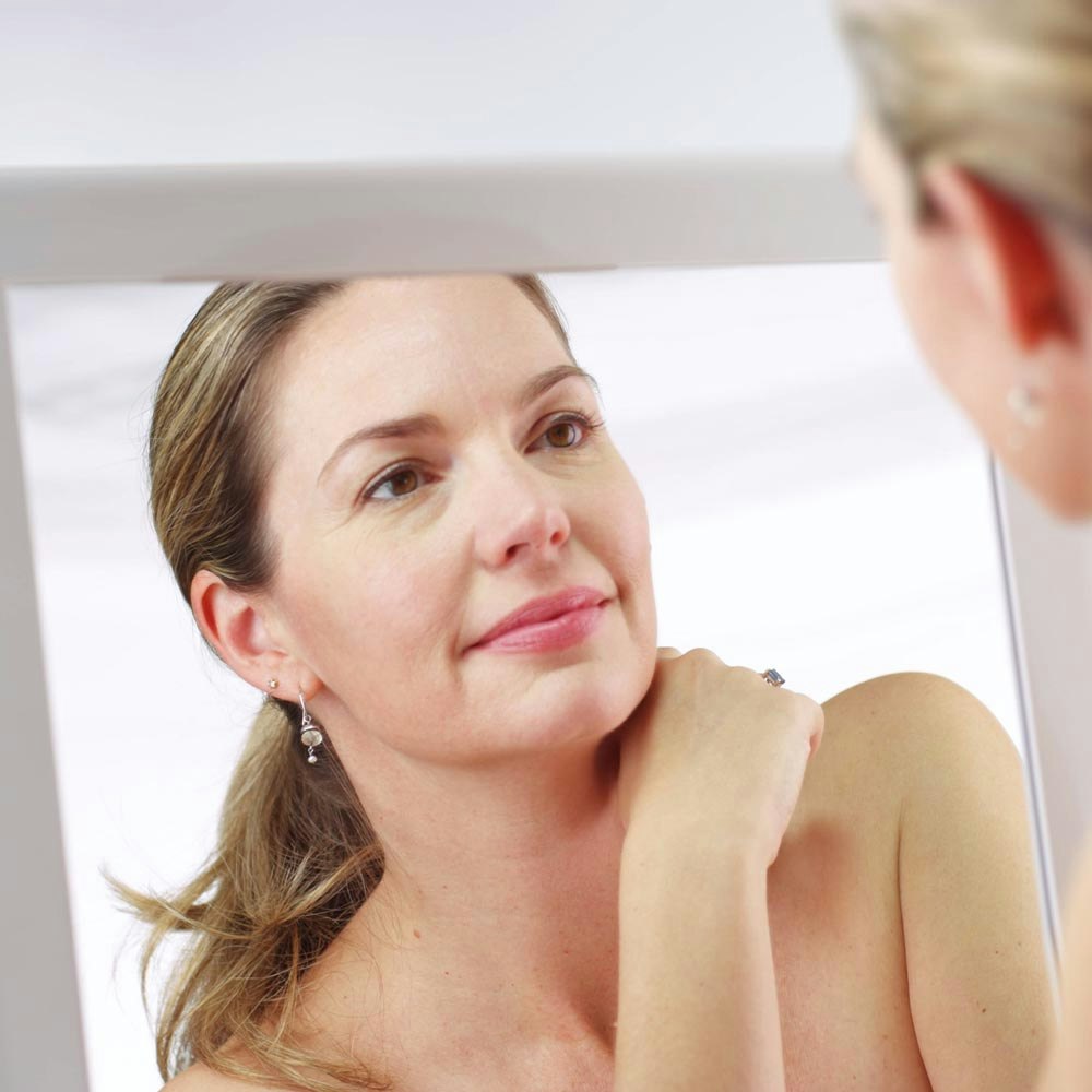 woman looking in mirror