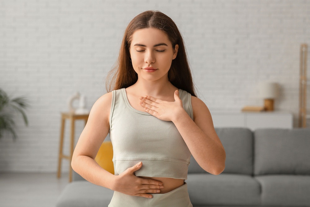 a woman breathing deeply through her nose