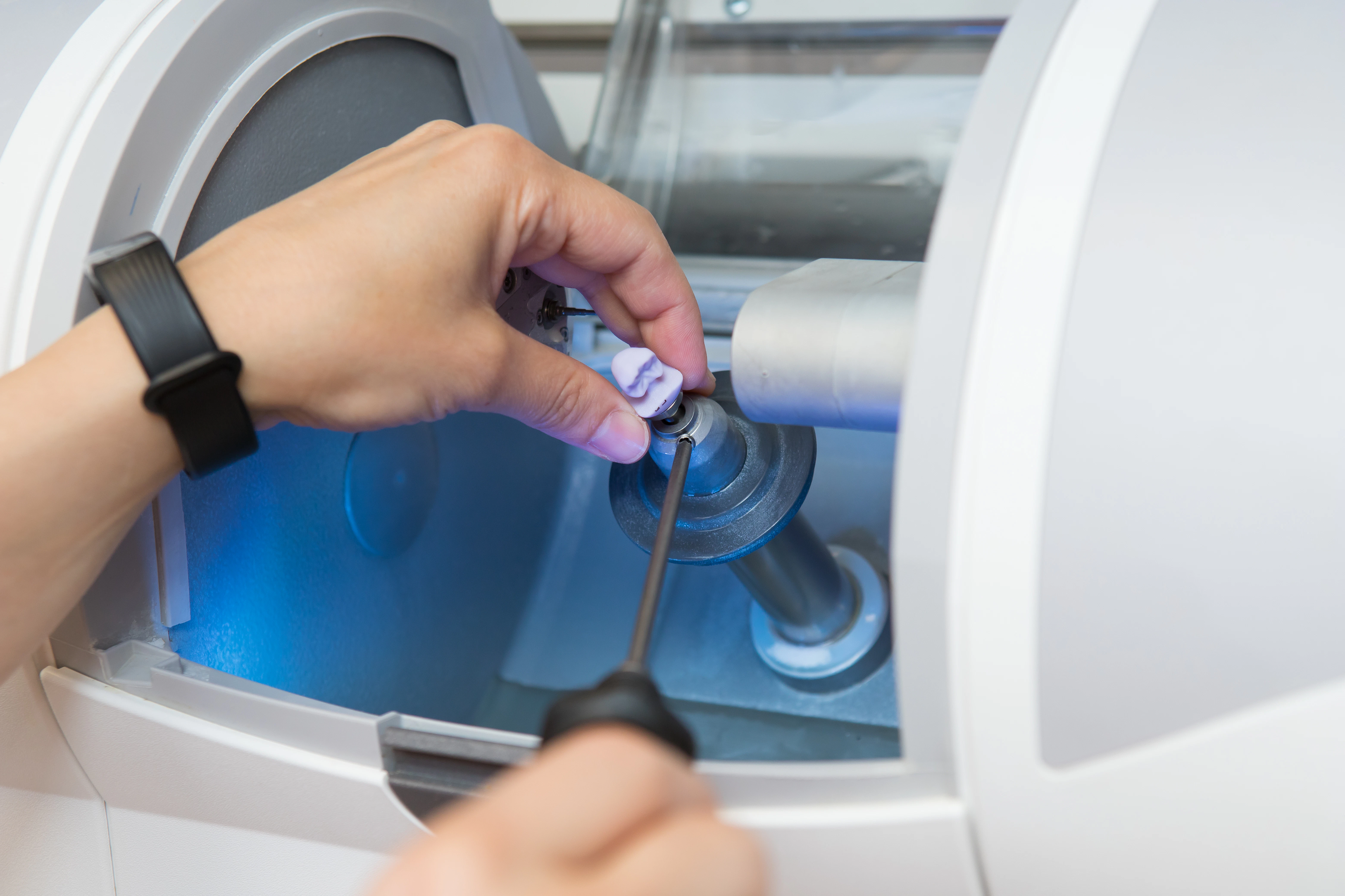 CEREC machine milling a crown