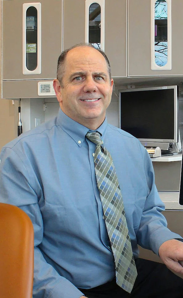 Photo of Dr. Slaman sitting in office chair