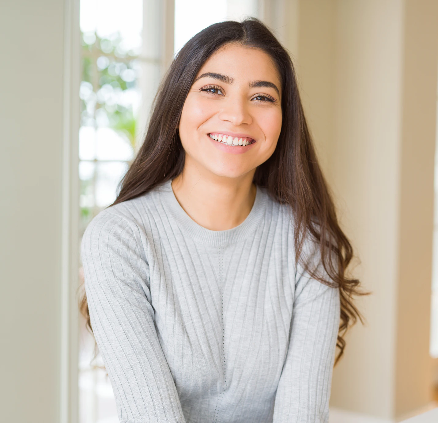 Woman in grey sweater smiling