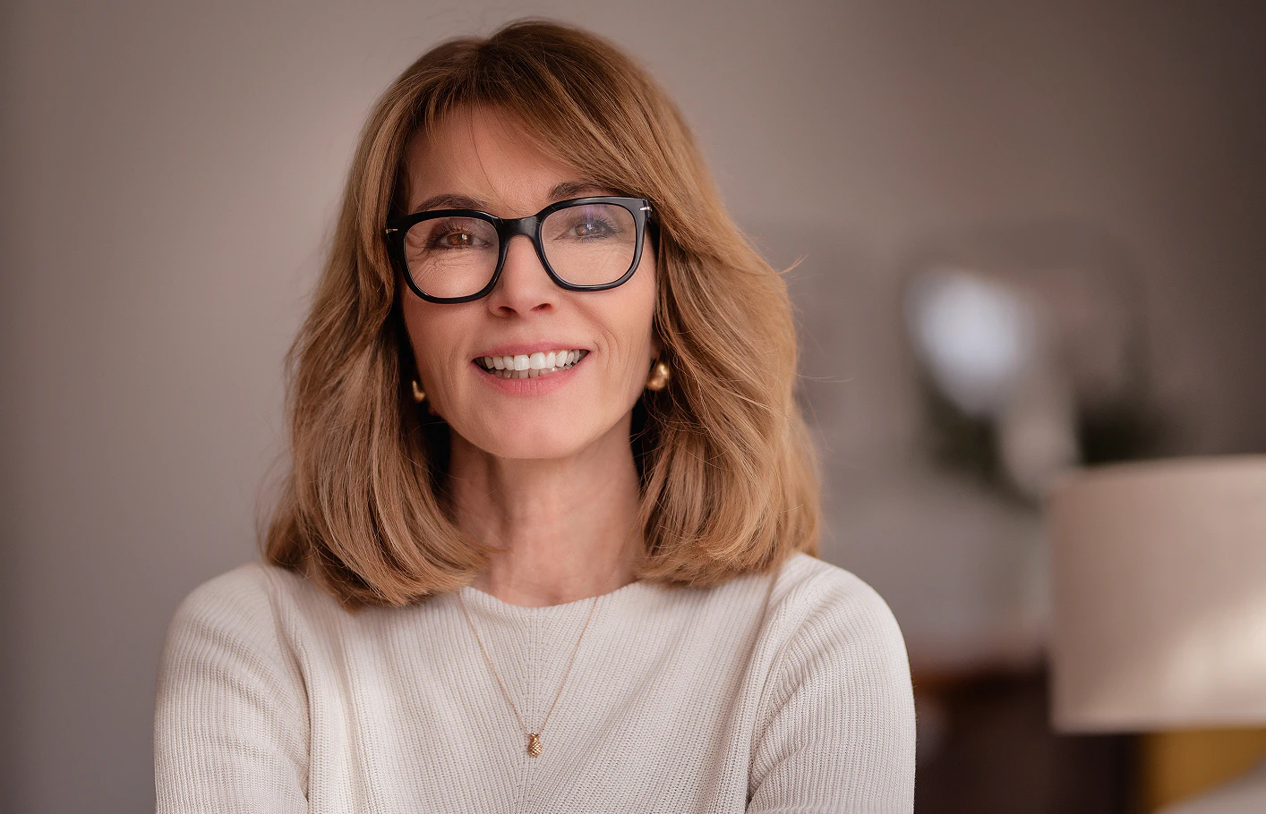 woman in glasses smiling