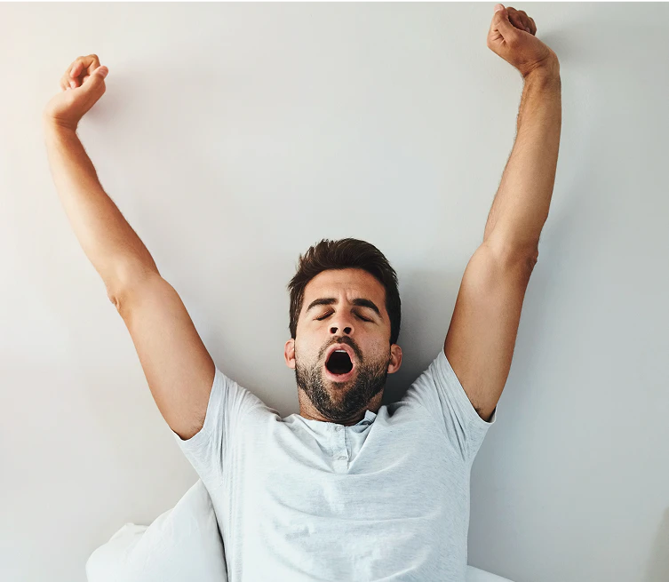 man yawning and stretching