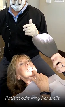 patient admiring her smile