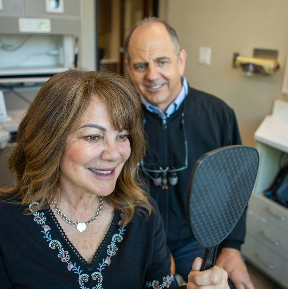 Dr. Slaman and patient admiring her new smile