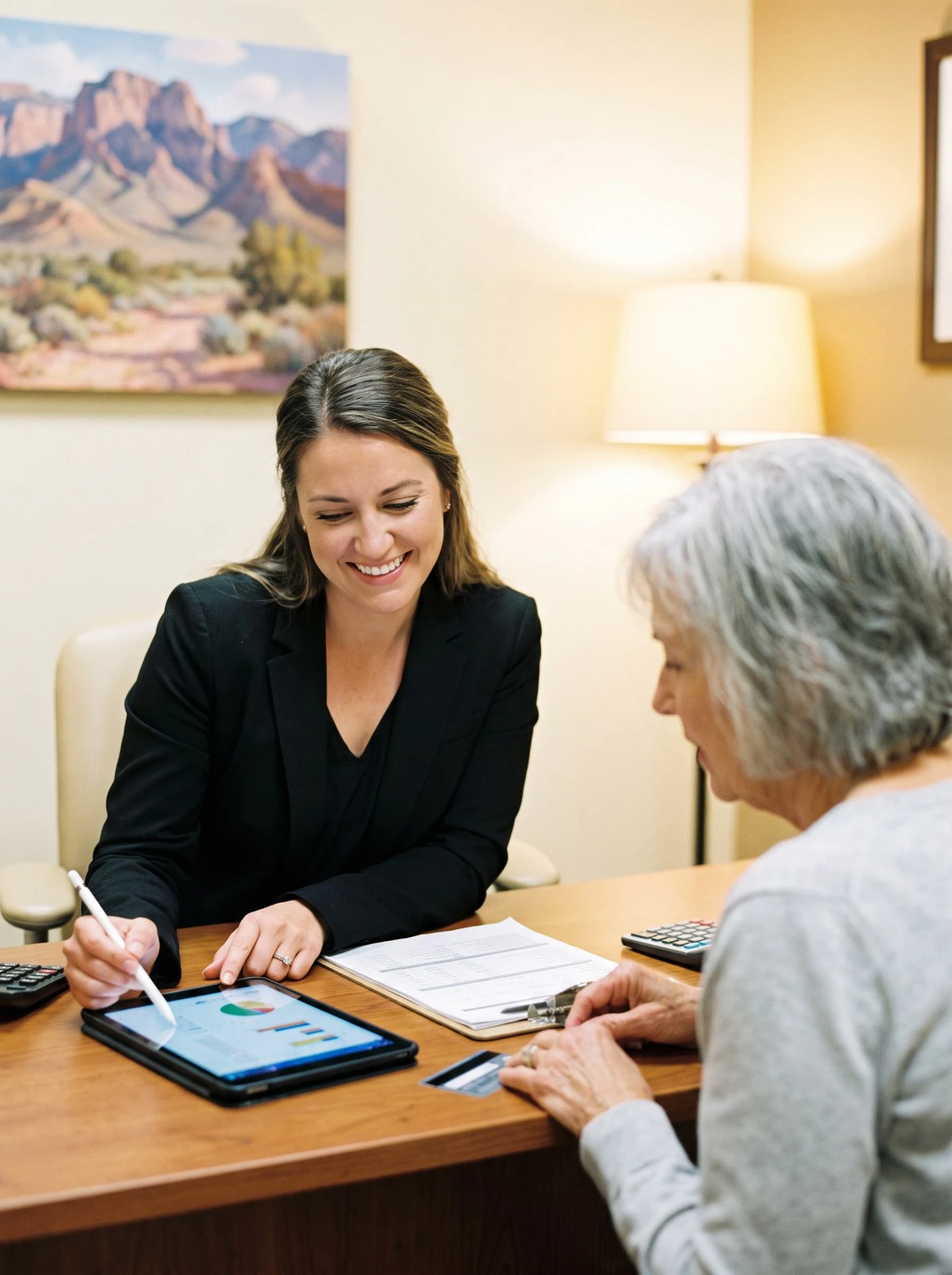 dental staff member explains financing to a patient