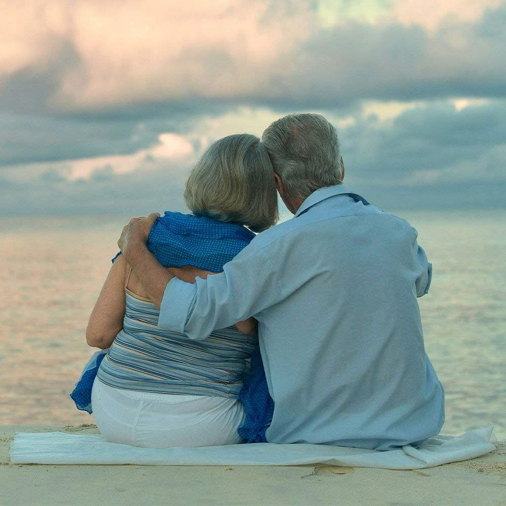 husband and wife looking at the ocean