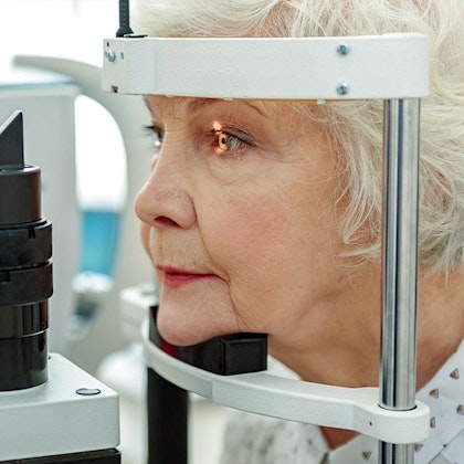 Woman undergoing slit lamp exam
