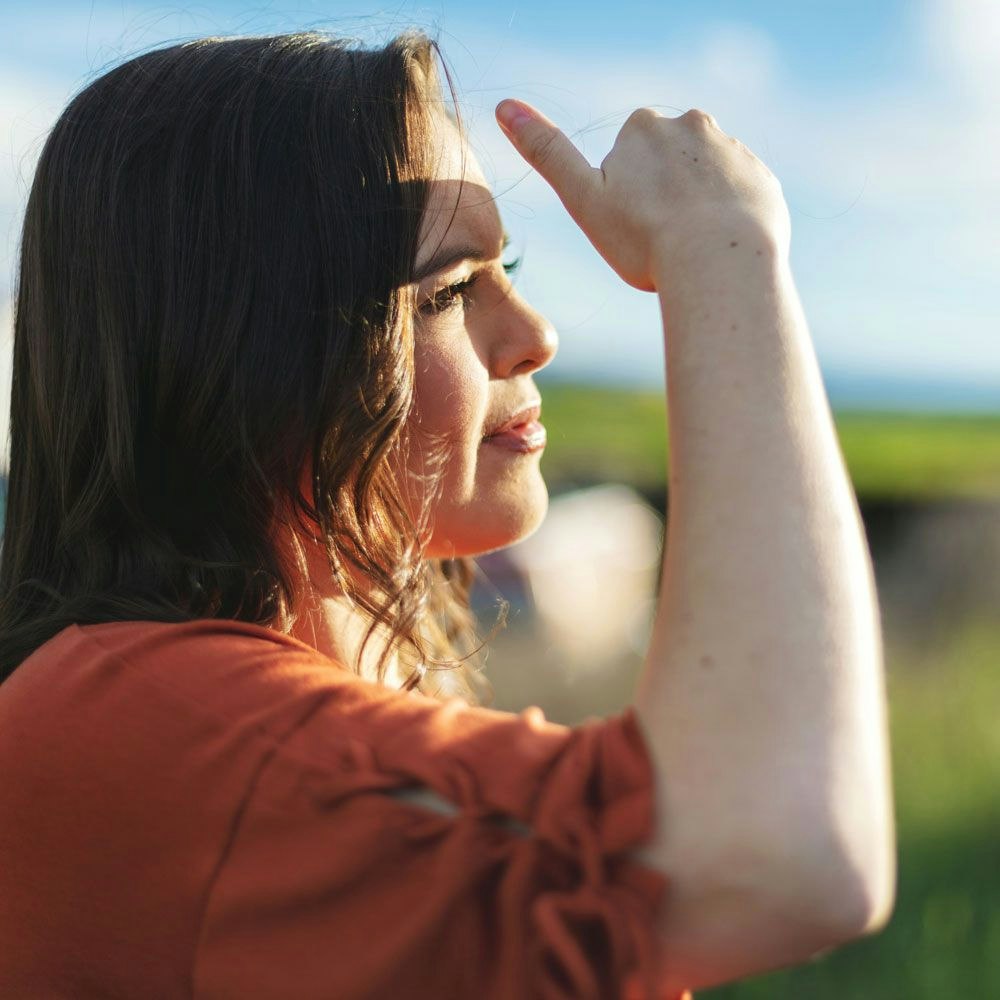Woman shading eyes from the sun