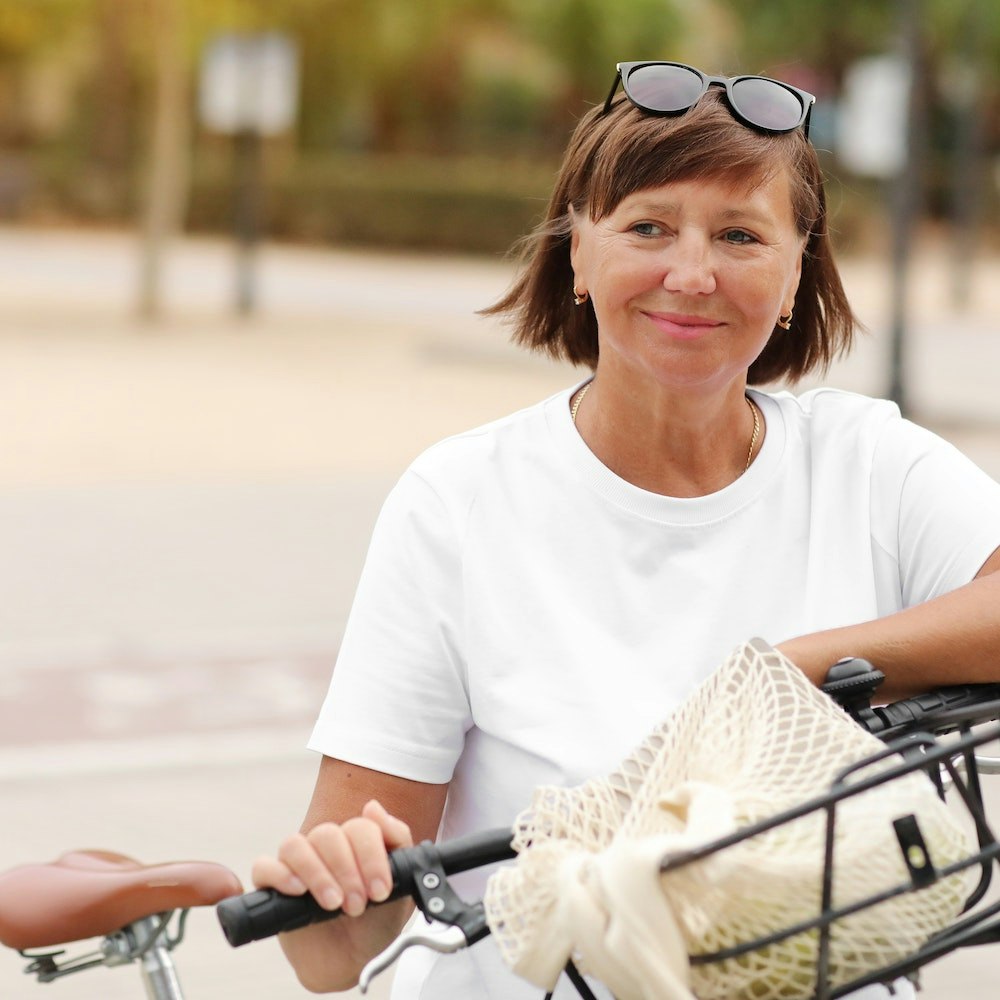 Smiling woman riding bike