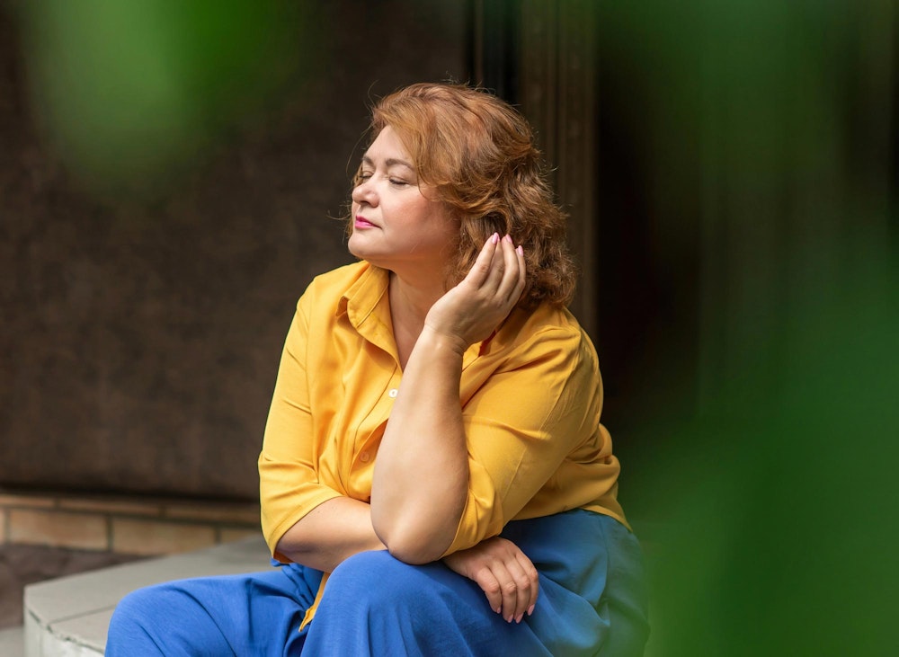 Mature woman eyes closed outside