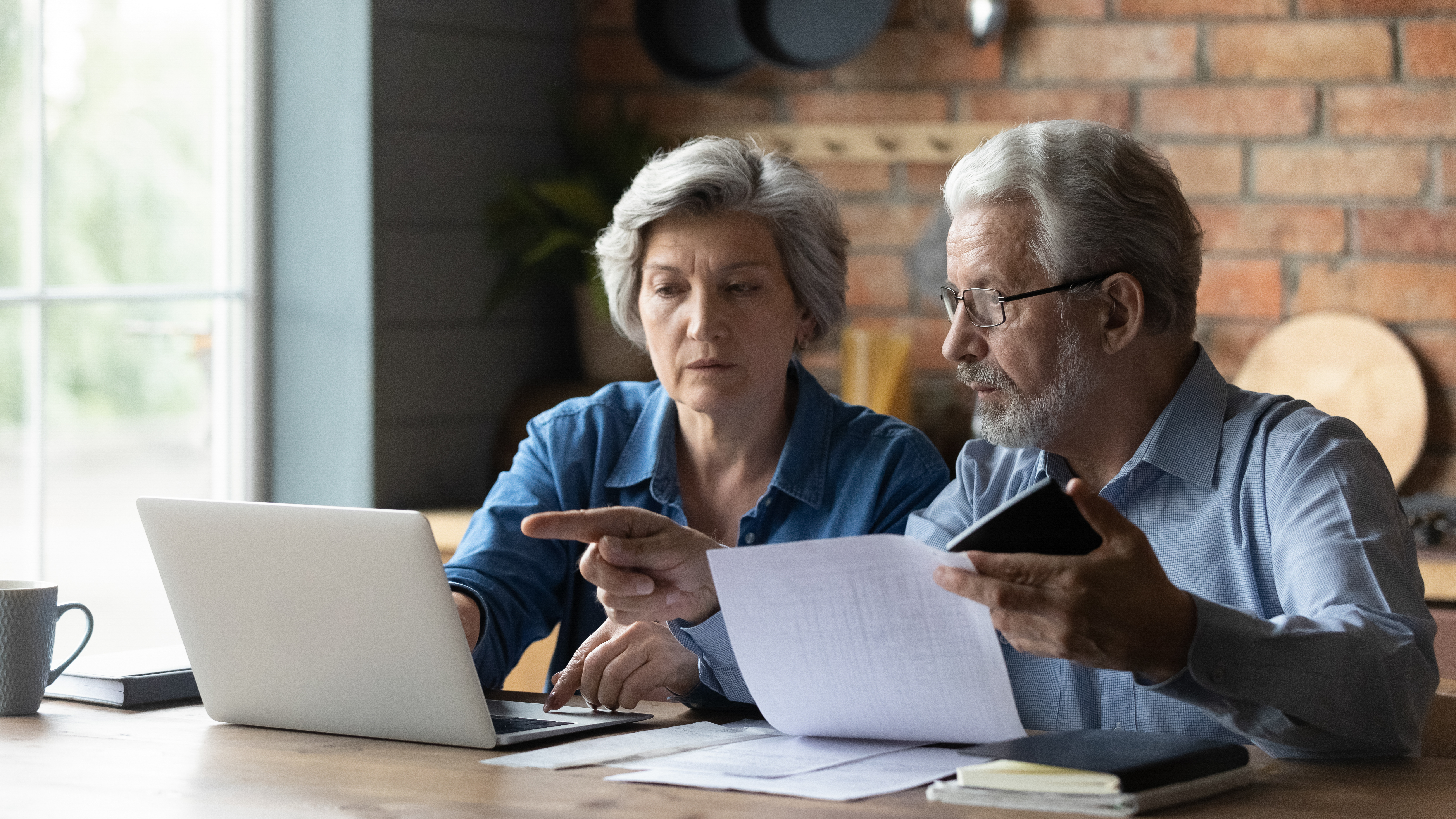 Senior couple looking over bills