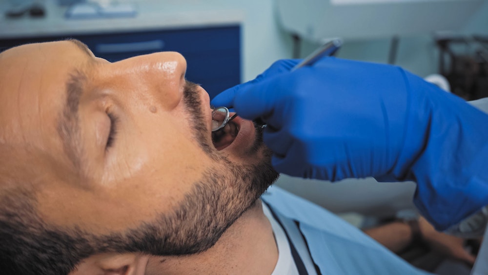 man comfortable at dental appointment