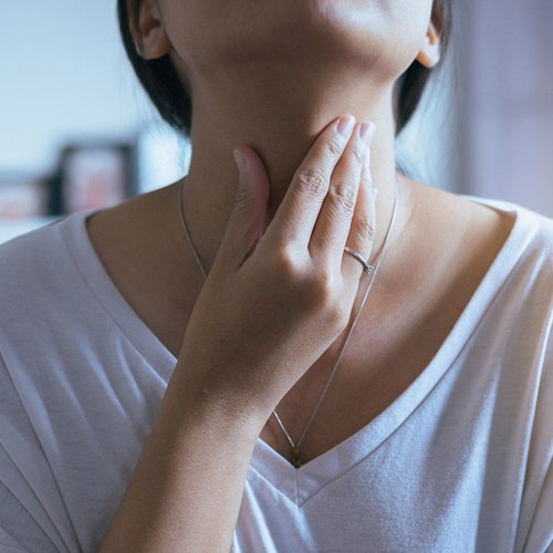 Woman touching throat