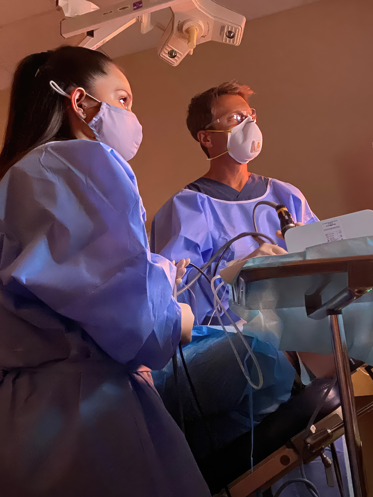 Dr. Cohen and a nurse performing treatment and looking at a monitor