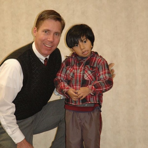 Dr. Griffiths posing for a picture with a boy