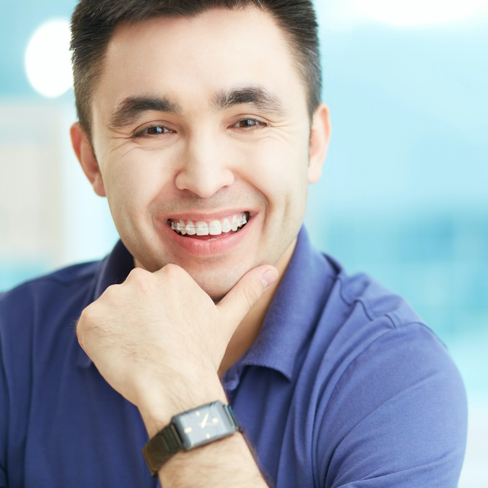Smiling middle-aged man wearing ceramic braces
