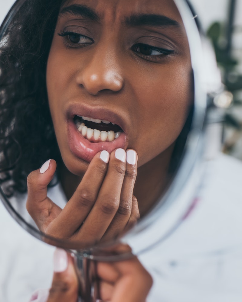 woman experiencing tooth pain and in need of wisdom tooth extraction