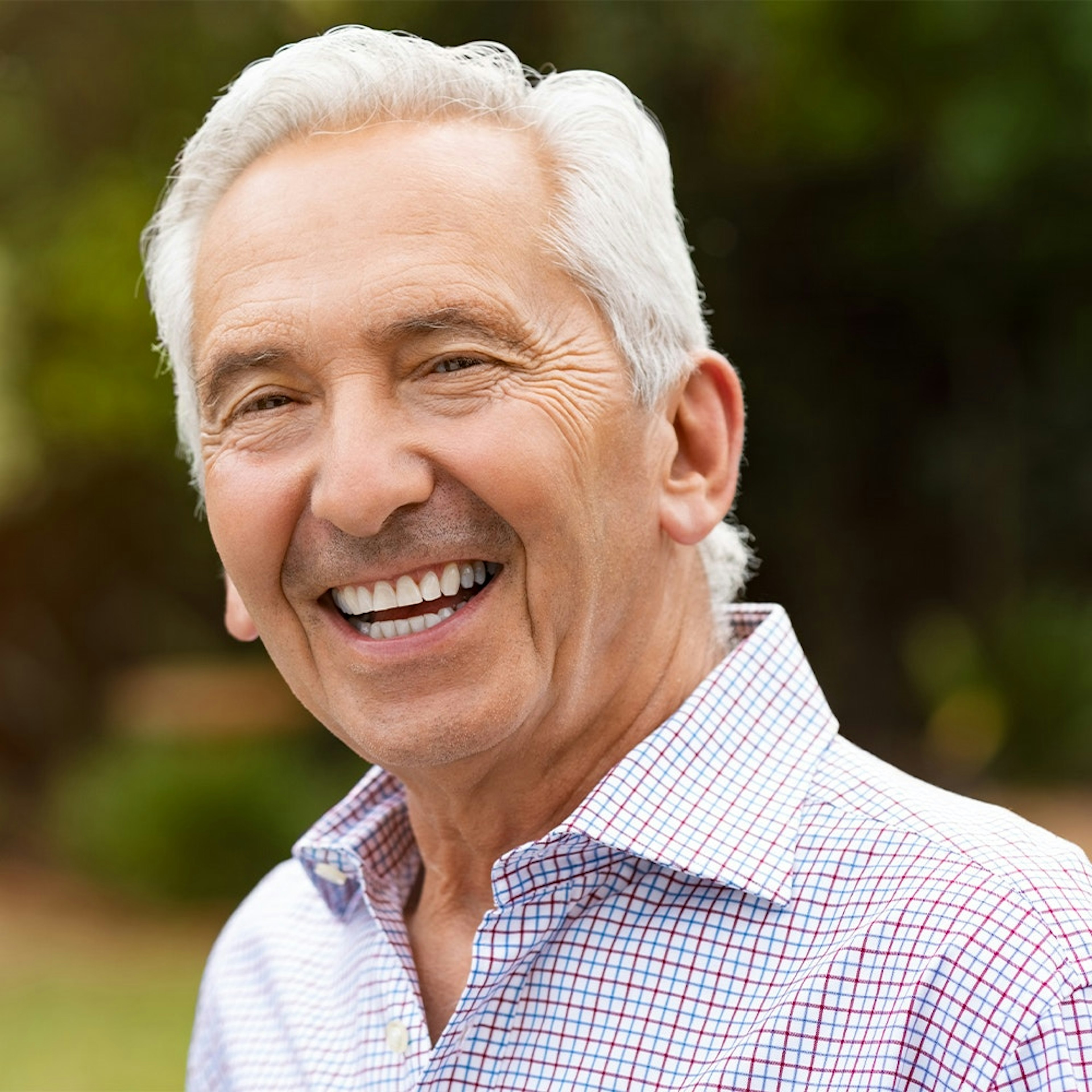 Mature man smiling after receiving dental bridge