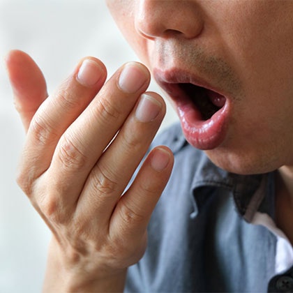 man suffering from gum disease smelling bad breath