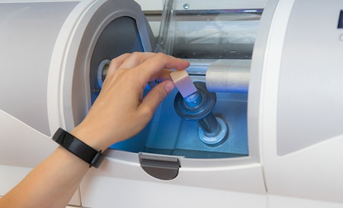 a person using a CEREC machine