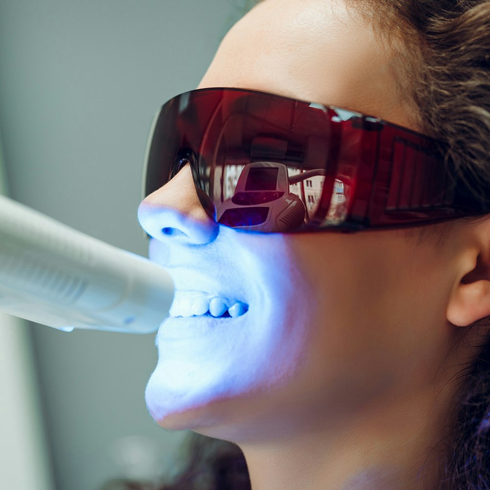 Woman receiving teeth whitening treatment