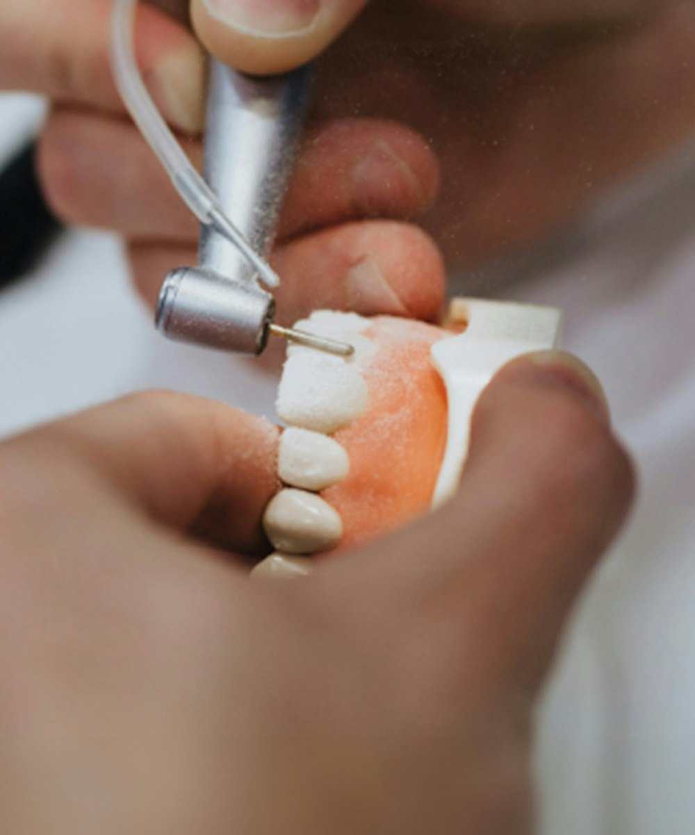 Lab tech hand-finishing a custom denture