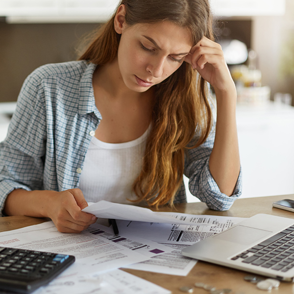 worried woman looking at finances