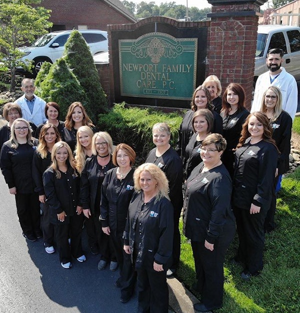 Newport Family Dental Care team standing by their business sign