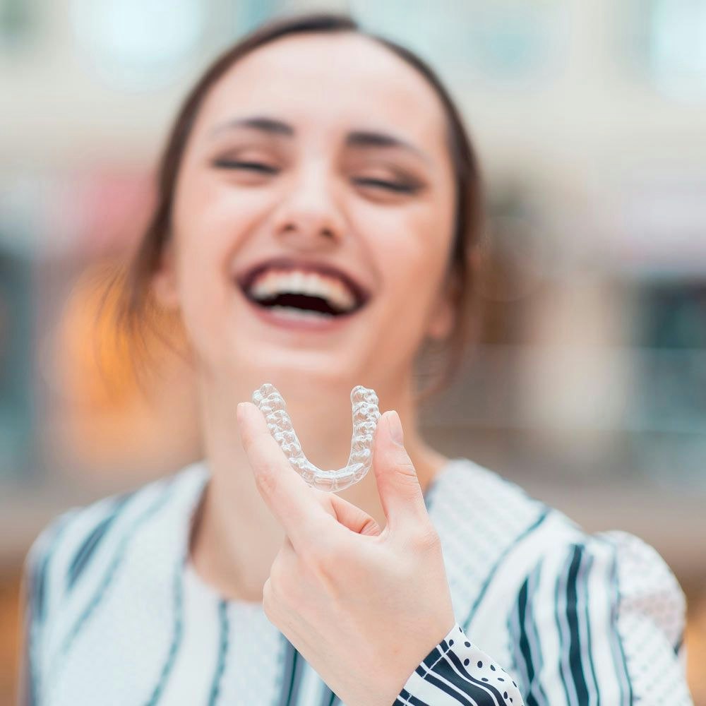 Woman holding a ClearCorrect