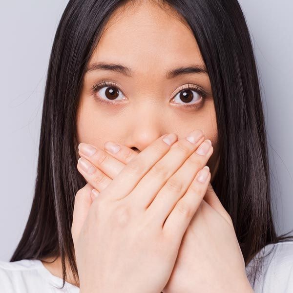 woman covering mouth