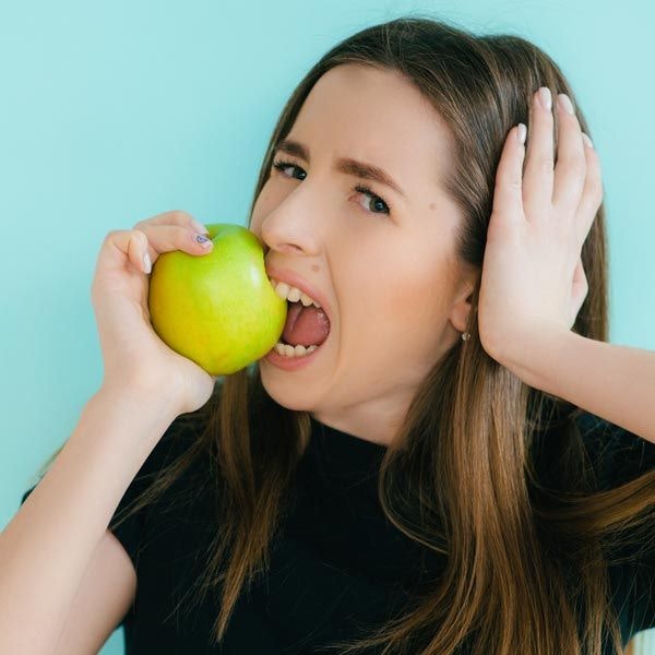woman biting into an apple