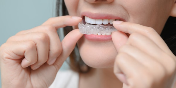 a woman putting in her retainer