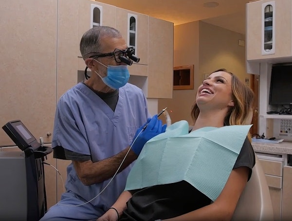 Dentist laughing with patient