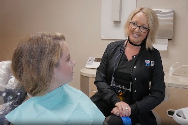 Hygienist talking with patient