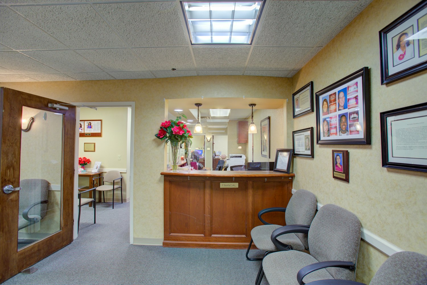 Interior image of the clean dental office with a comforting pink wall and chair