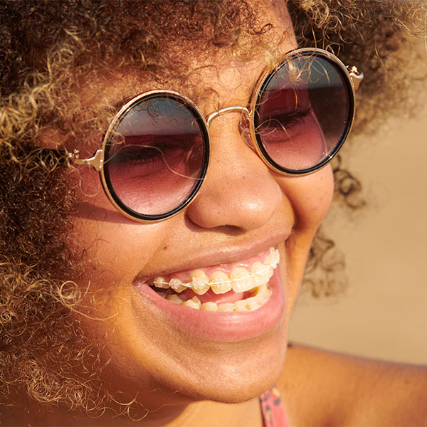 young woman smiling with clear braces