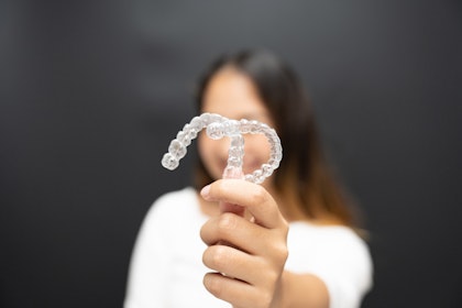 person holding clear retainers