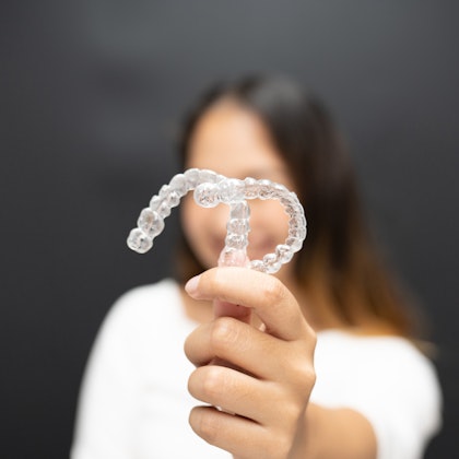 person holding clear retainers