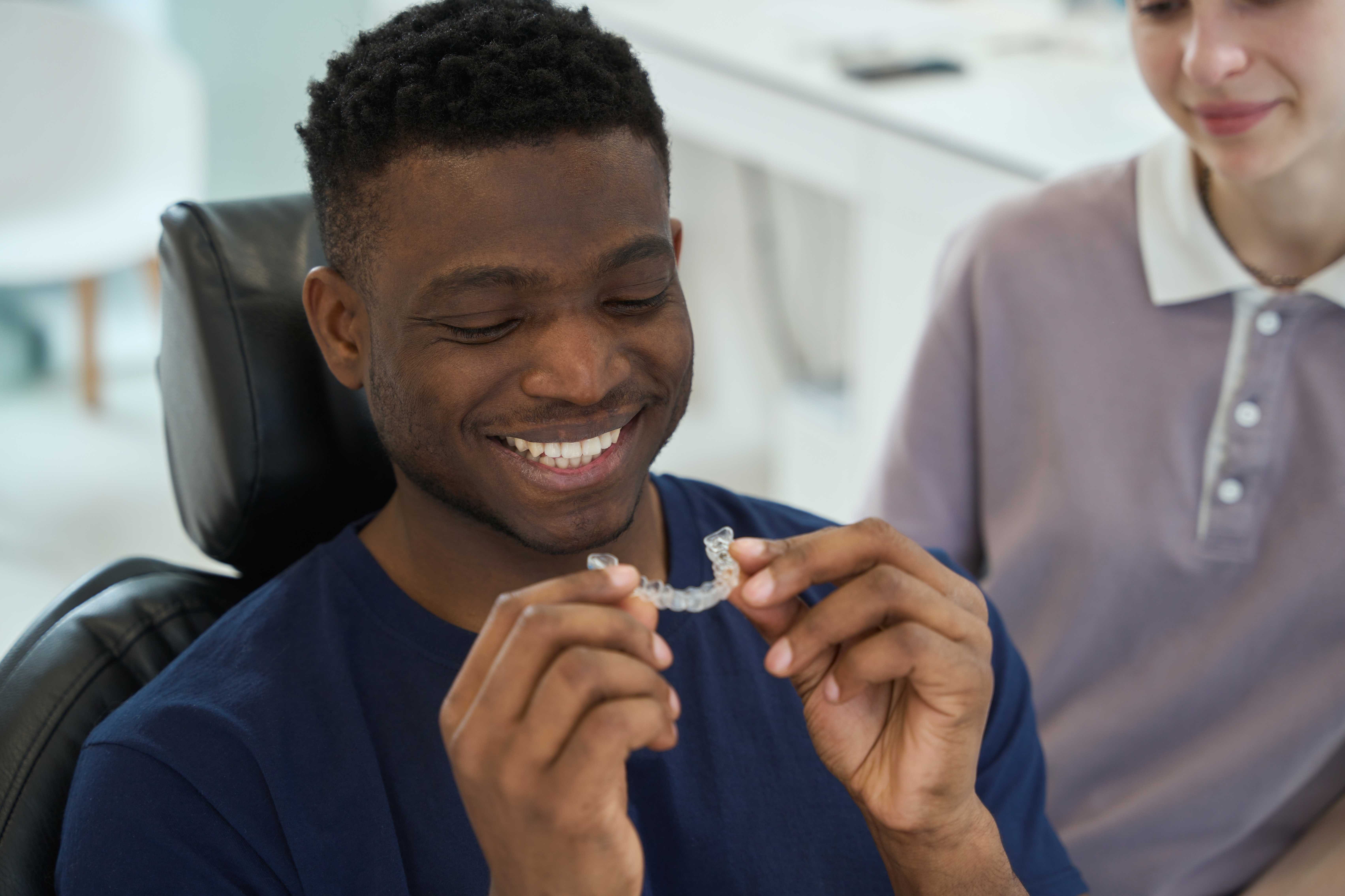 Man in dental chair looking at Invisalign