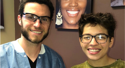 Smiling patient posing with staff