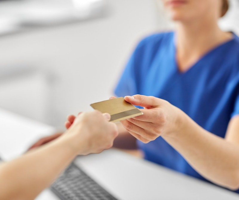 a person making a payment at the dentist