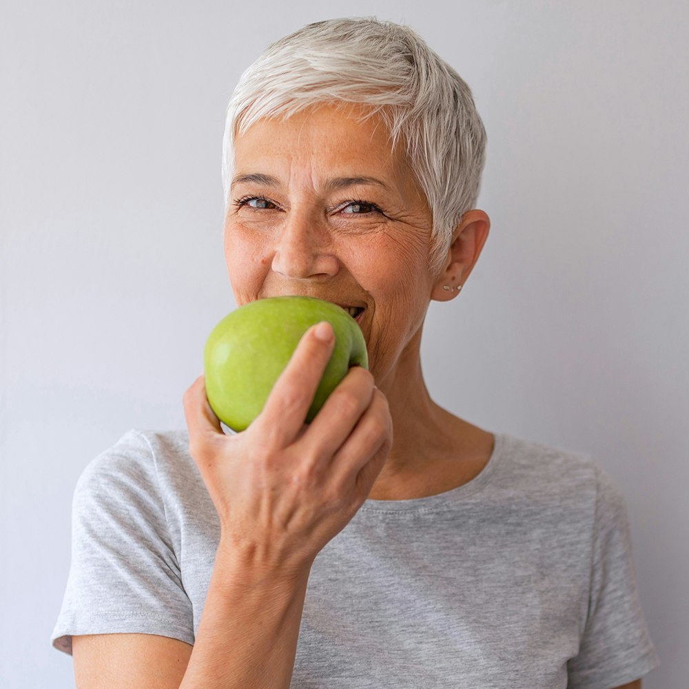 Woman biting into an apple