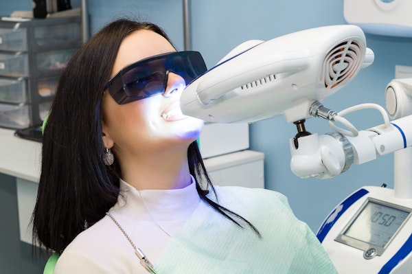 Girl undergoing teeth whitening at the dentist