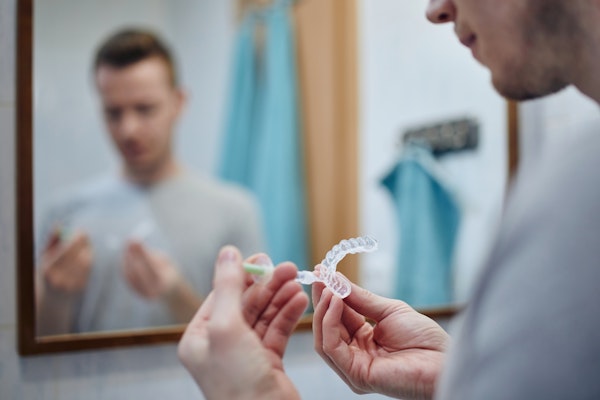Man putting gel in whitening tray at home