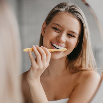 Woman brushing teeth