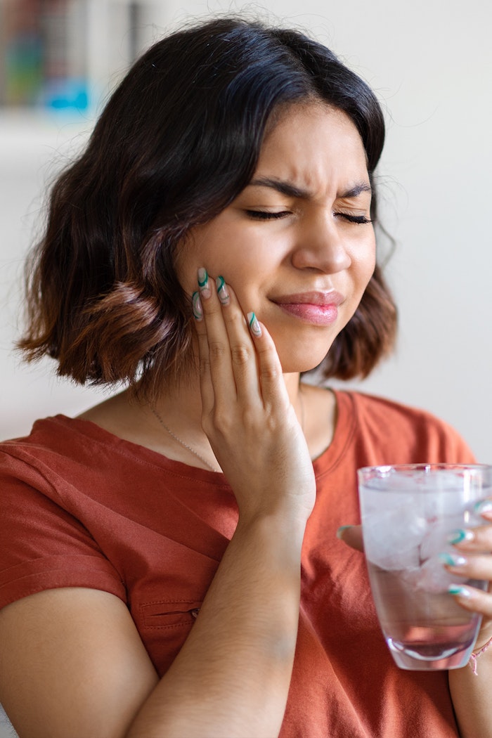 a woman experiencing tooth pain
