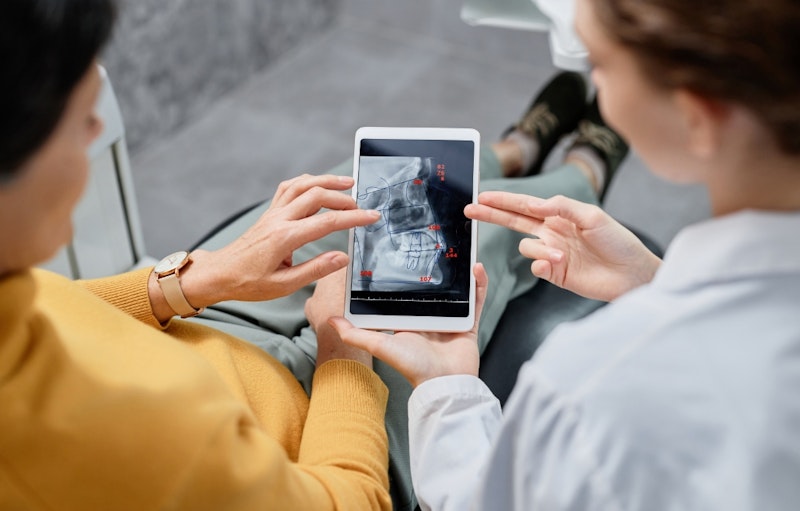 Fairfax dentist and patient discussing costs during an oral surgery consultation